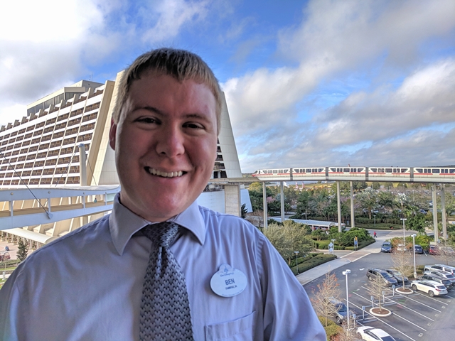 Photo of Ben Waychoff standing in front of the monorail train site at Disneyland