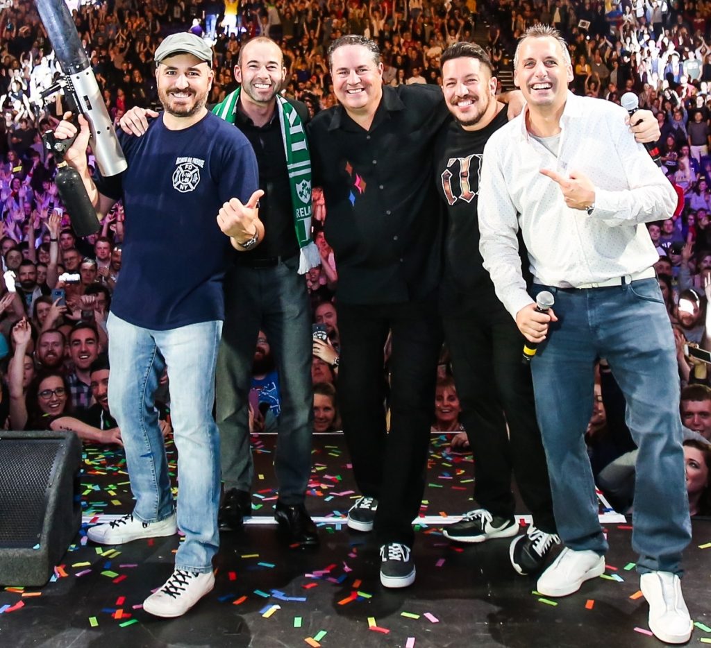 Jeff Johnson (Center) on stage with the Practical Jokers with the crowd behind them.