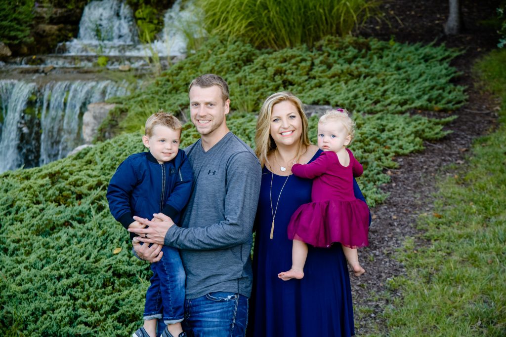 Photo of Morgan and her family in front of a waterfall.